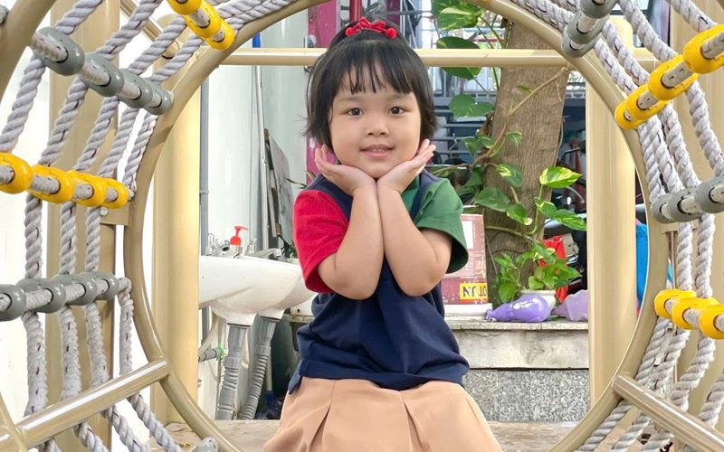 Bé tươi cười ở khu vui chơi vận động